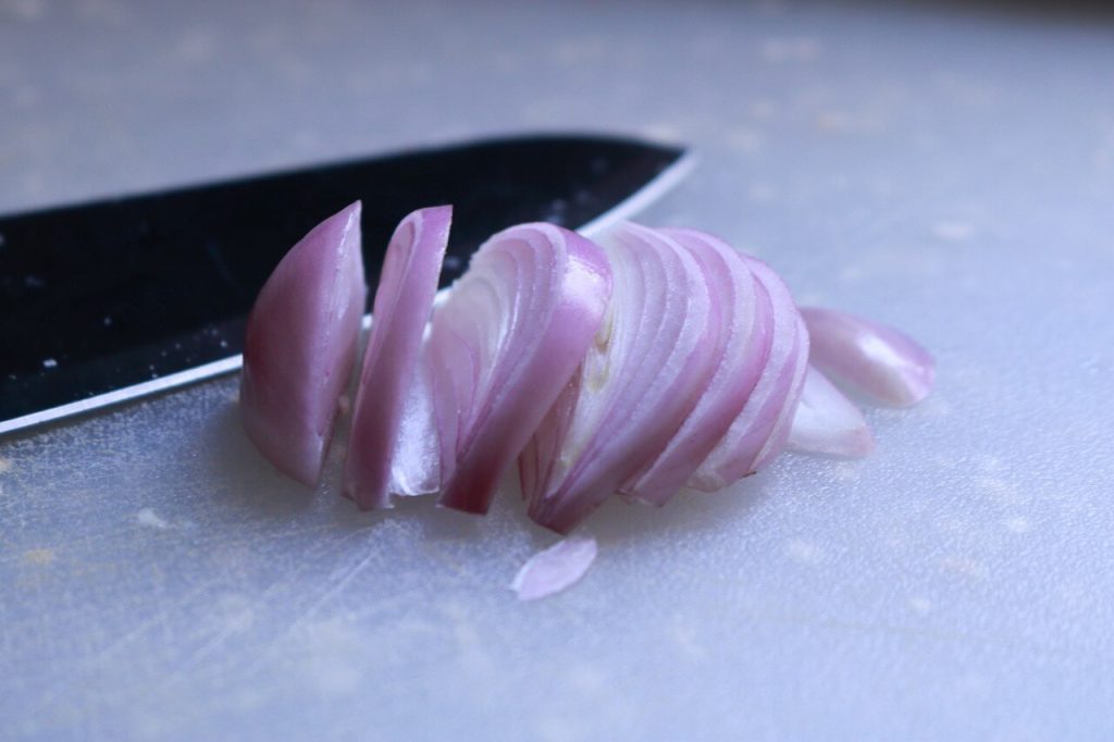 A knife and sliced onion