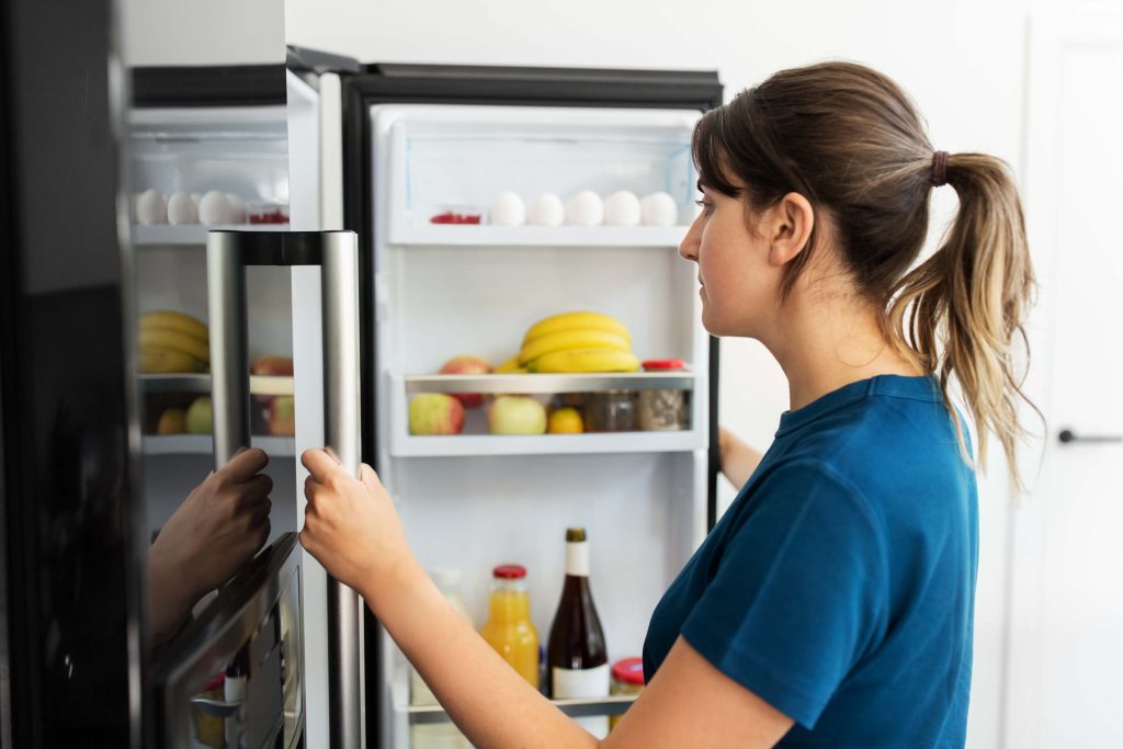 A person opening a refrigerator