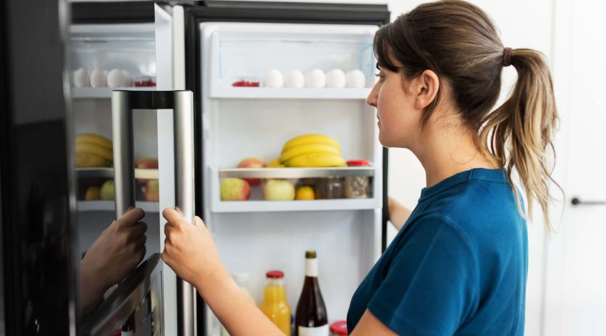 A person opening a refrigerator
