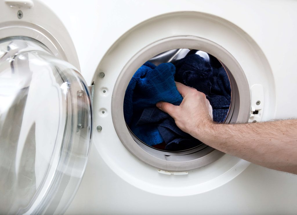 putting garments in the washer