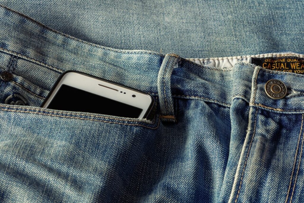 A cell phone in a pocket of jeans
