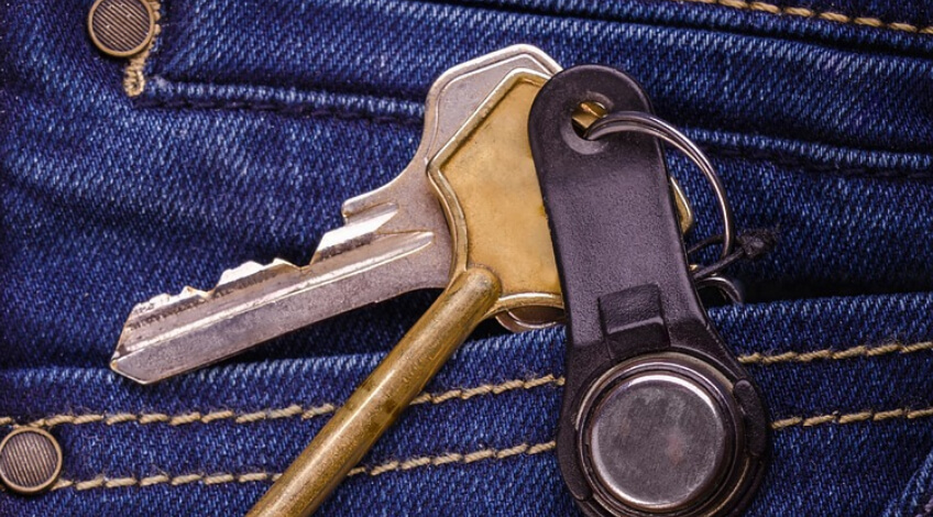 A pair of keys in a pocket of jeans