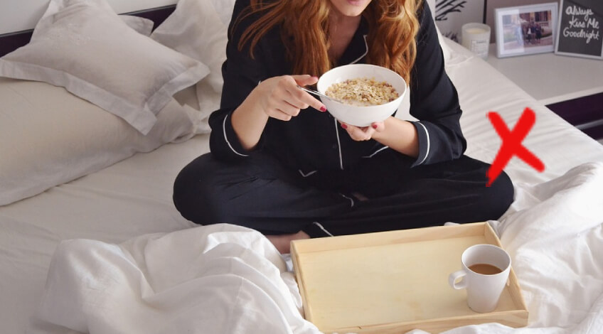 person eating breakfast in bed