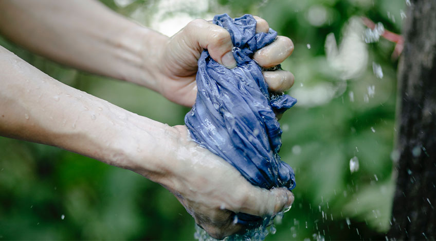 person wringing clothes by hand