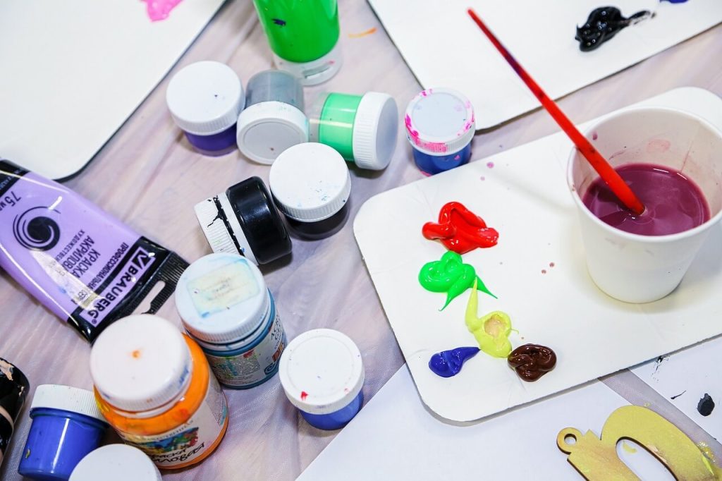 A table with paint and brushes