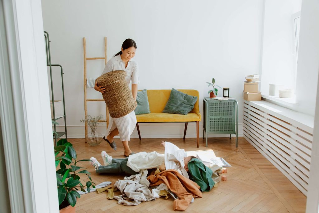 person with pile of clothes