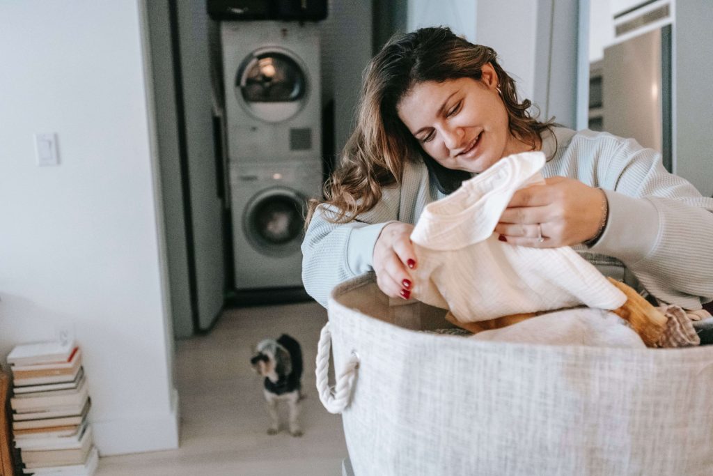 person checking clothes in laundry basket