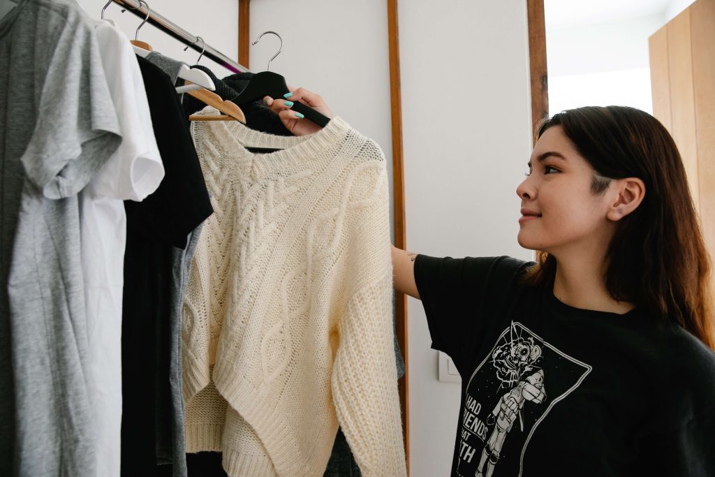 person hanging clothes indoors