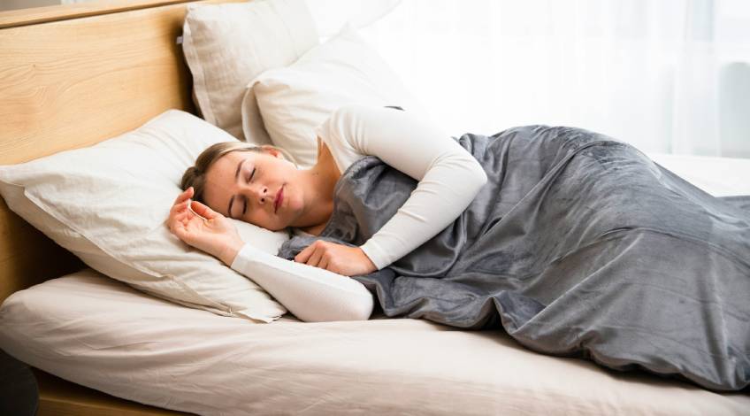 person sleeping with an electric blanket