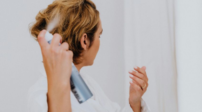 person using a hairspray