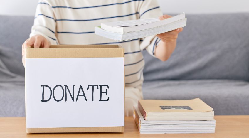 person decluttering books for donation