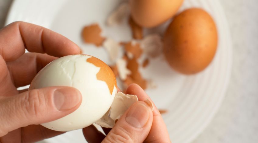 person peeling hard boild eggs
