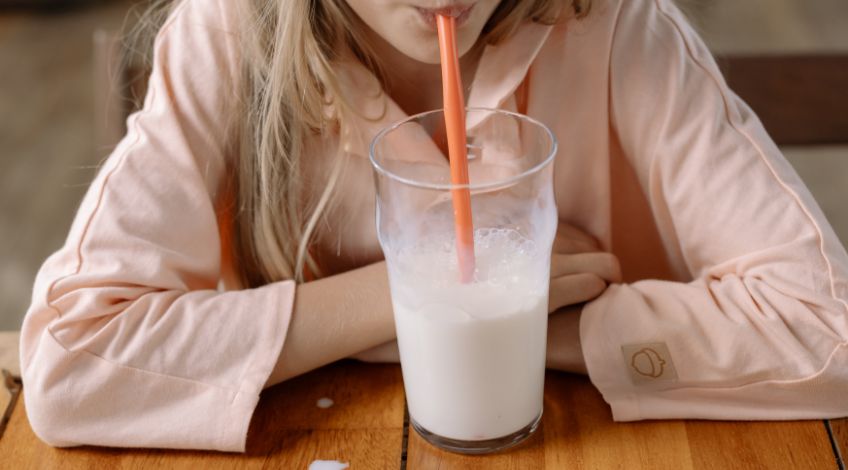 woman drinking milk with straw