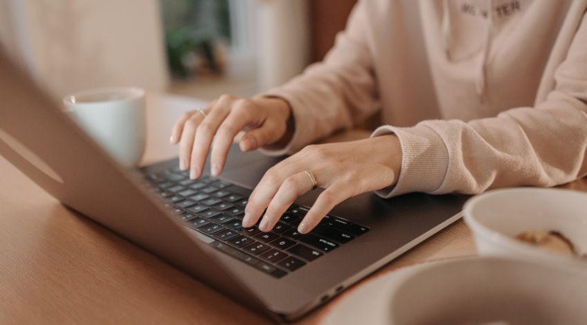 person typing on a laptop
